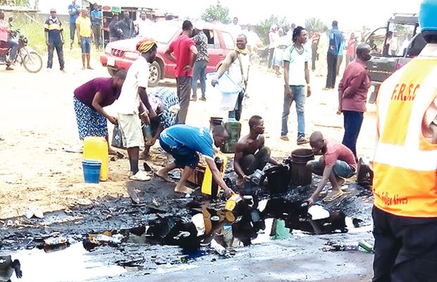 Danger averted as youth scoop petrol from falling tanker